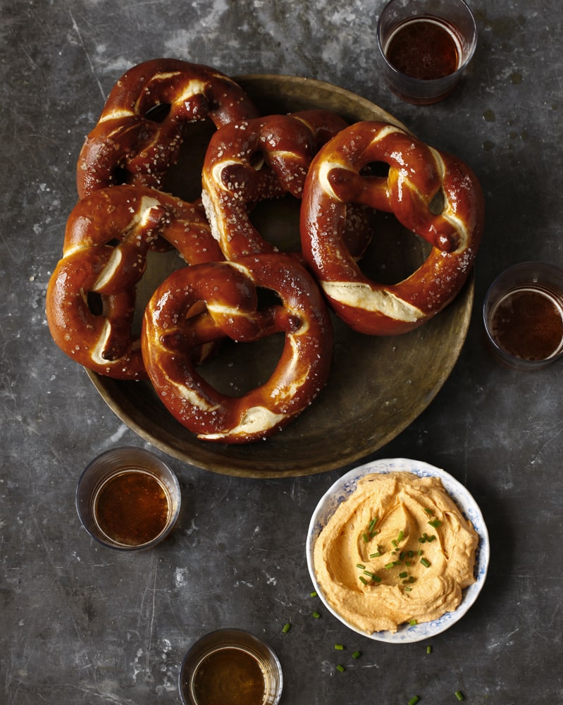 Bavarian pretzel served with Obatzda, a delicious cheese spread perfect for pretzels.